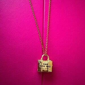 Marc Jacob pendant on a 16” stainless steel necklace